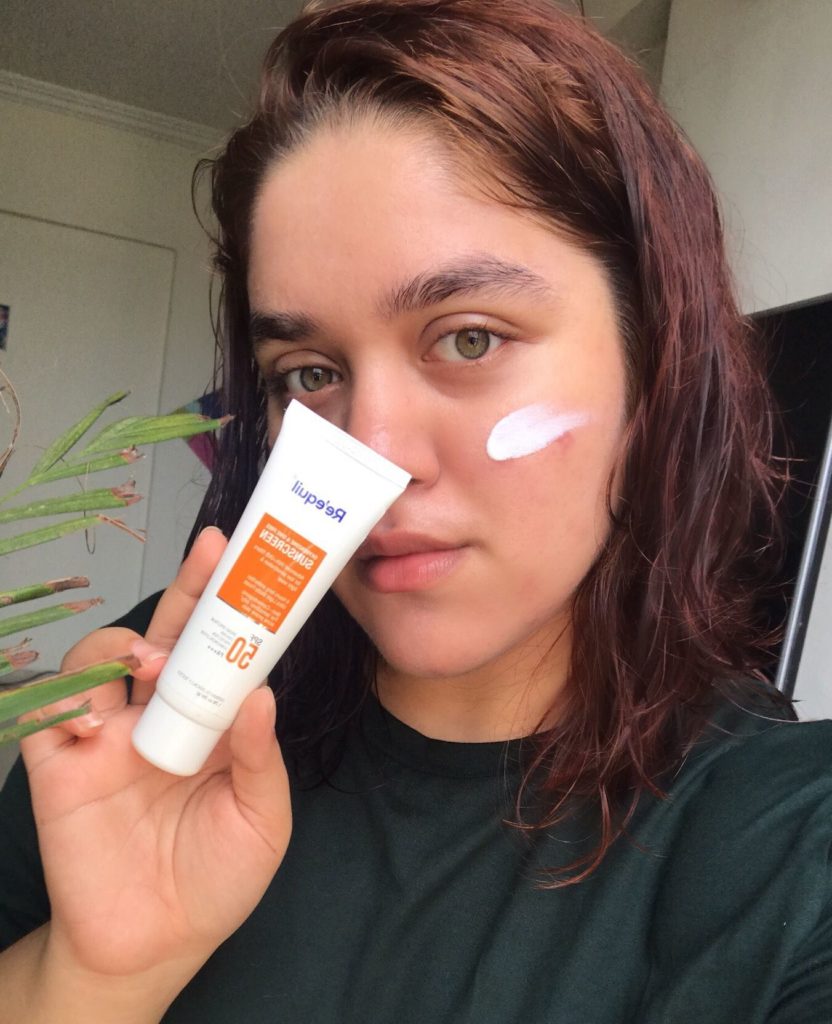 Holding the sunscreen to show its texture